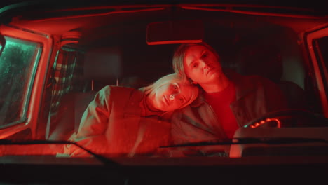 Portrait-of-Romantic-Couple-in-Car-with-Red-Light